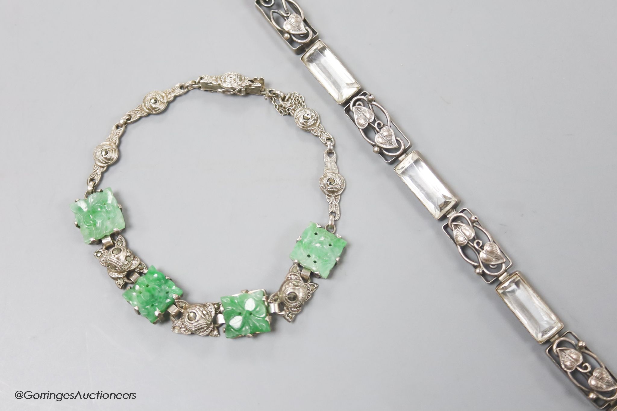 A white metal and carved jade set bracelet and one other bracelet.